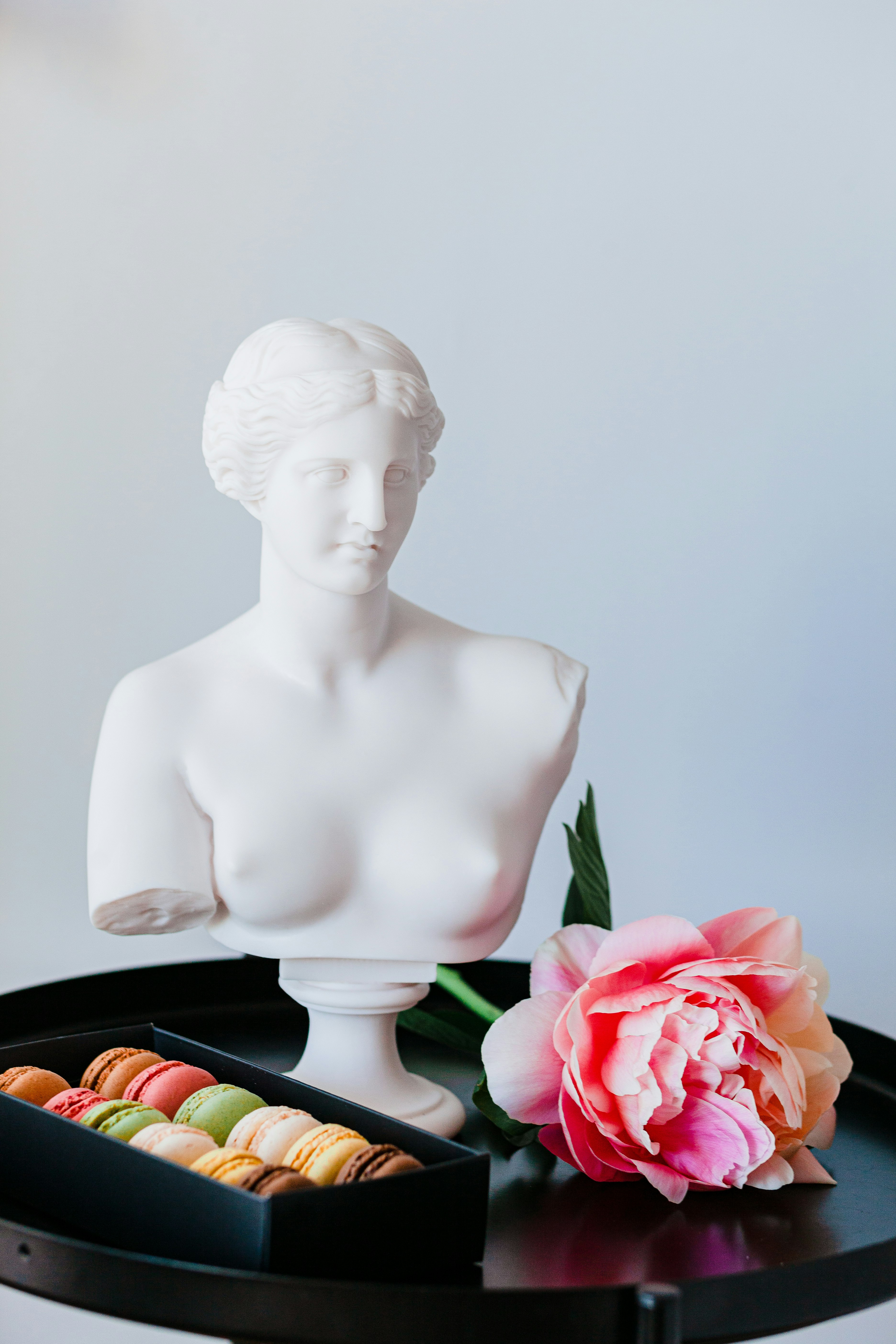 white ceramic woman figurine beside red rose